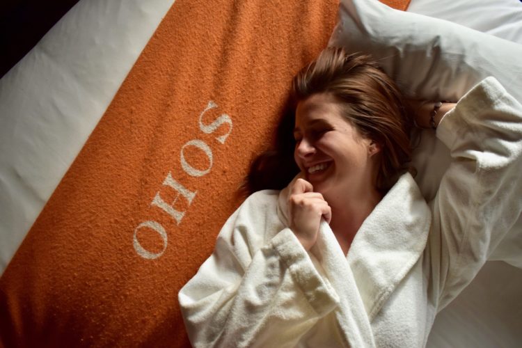 laughing-on-bed-soho-grand-hotel